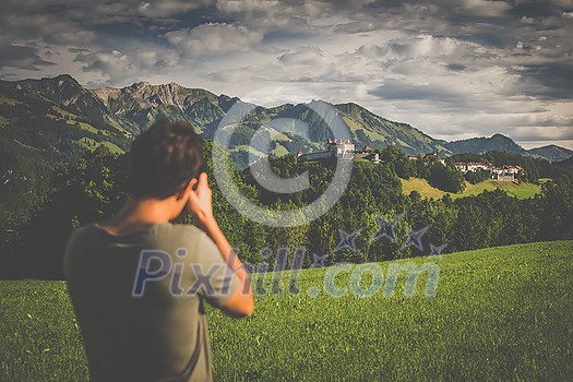 Photographer taking photos of the splendid medieval village of Gruyères, Switzerland Photographer taking photos of the splendid medieval village of Gruyères, Switzerland