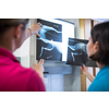 Two female vet doctors looking at x-ray photos of an injured cat