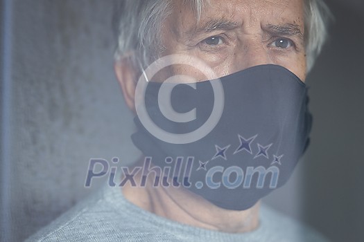 Senior man wearing a facemask during coronavirus and flu outbreak. Virus and illness protection, home quarantine. COVID-19 concept Senior man wearing a facemask during coronavirus and flu outbreak. Virus and illness protection, home quarantine. COVID-19 concept
