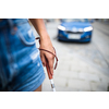 Blind woman walking on city streets, using her white cane to navigate the urban space better and to get to her destination safely