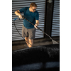 Young man washing his beloved car carefully in a manual car wash to prevent any damage and detail it properly