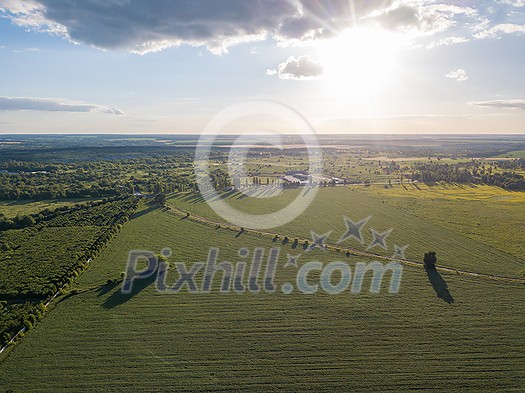 Panoramic bird's eye view from drone of outdoors landscape above farmlands, agricultural fields, and forests on bright sky background on a summer sunny day. Ukraine, Uman city. Panoramic bird's eye view from drone of outdoors landscape above farmlands, agricultural fields, and forests on bright sky background on a summer sunny day. Ukraine, Uman city.