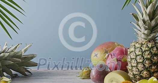Summer healthy exotic fruits - passion fruit, coconut and mango with palm leaf on a gray wooden table on a blue Vegetarian healthy concept. Dolly out motion, 4K video, 3840, 2160p. Summer healthy exotic fruits - passion fruit, coconut and mango with palm leaf on a gray wooden table on a blue Vegetarian healthy concept. Dolly out motion, 4K video, 3840, 2160p.