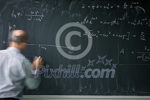 Math teacher drawing fuction graph on a blackboard during mathclass (motion blurred image) Math teacher drawing fuction graph on a blackboard during mathclass (motion blurred image)