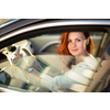 Pretty, young woman  driving a car -Invitation to travel. Car rental or vacation.