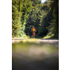 Pretty, young woman biking on a mountain bike enjoying healthy active lifestyle outdoors in summer (shallow DOF)