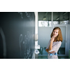 Pretty, young female student in front of a blackboard during math class