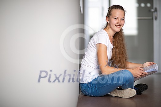 Cute female university/highschool student with books in library Cute female university/highschool student with books in library