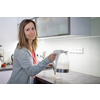 Pretty, young woman in her modern bright kitchen - making tea, healthy eating concept, household lifestyle concept