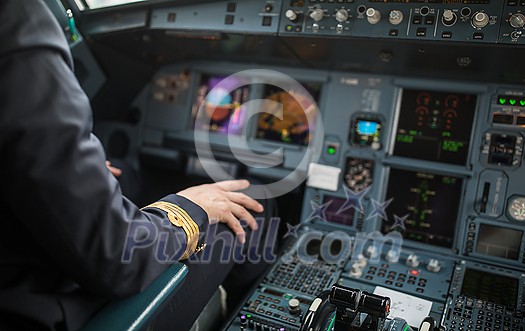 Pilot's hand accelerating on the throttle in a commercial airliner airplane flight cockpit during takeoff Pilot's hand accelerating on the throttle in a commercial airliner airplane flight cockpit during takeoff