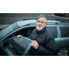Senior man smiling, happy about his new car