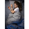 Pretty, young woman sleeping in her bed late in the morning on a weekend - compensating for the lack of sleep