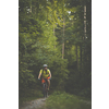 Young man with his mountain bike going for a ride past the city limits in a lovely forest, getting the daily cardio dose
