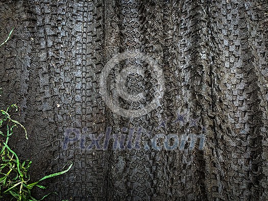 Traces of bike tires in the mud. Riding a bike through the mud. Mountain Biker Riding Through A Dirty Puddle Traces of bike tires in the mud. Riding a bike through the mud. Mountain Biker Riding Through A Dirty Puddle