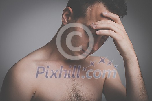 Depressed young man going through a rough patch in his life - suffering from mental exhaustion, anxiety, burnout, depression (colour toned image) Depressed young man going through a rough patch in his life - suffering from mental exhaustion, anxiety, burnout, depression (colour toned image)
