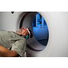Senior man going through a Computerized Axial Tomography (CAT) Scan medical test/examination in a modern hospital (color toned image; shallow DOF)