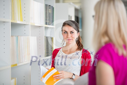 Pretty young college student in a library (shallow DOF; color toned image) Pretty young college student in a library (shallow DOF; color toned image)