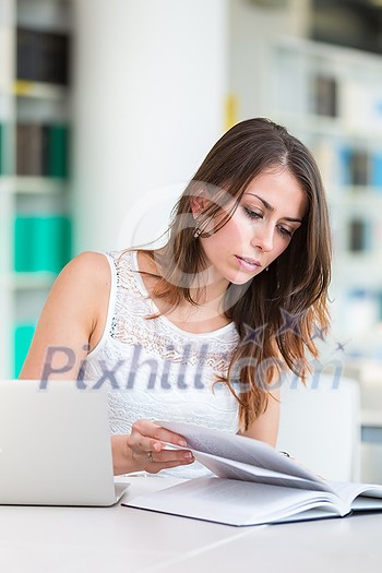 Pretty young college student in a library (shallow DOF; color toned image) Pretty young college student in a library (shallow DOF; color toned image)
