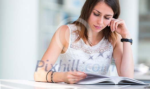 Pretty young college student in a library (shallow DOF; color toned image) Pretty young college student in a library (shallow DOF; color toned image)