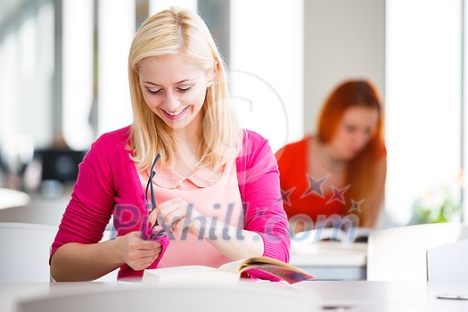 Pretty young college student in a library (shallow DOF; color toned image) Pretty young college student in a library (shallow DOF; color toned image)