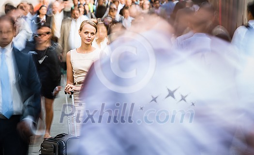 Crowd of people walking on city street - motion blurred image with unrecognizable faces - Young woman standing still, feeling down, depressed Crowd of people walking on city street - motion blurred image with unrecognizable faces - Young woman standing still, feeling down, depressed
