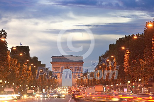 Beautiful night view with car traffic and rush at eavning of the Arc de Triomphe, Paris, France. Beautiful night view with car traffic and rush at eavning of the Arc de Triomphe, Paris, France.