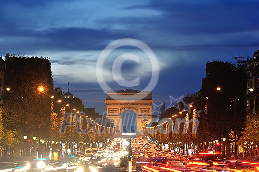 Beautiful night view with car traffic and rush at eavning of the Arc de Triomphe, Paris, France. Beautiful night view with car traffic and rush at eavning of the Arc de Triomphe, Paris, France.