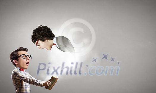 Funny big headed man in glasses with book in hands Funny big headed man in glasses with book in hands