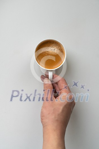 Man holding tasty aromatic cup of coffee on white background, cropped image Man holding tasty aromatic cup of coffee on white background, cropped image