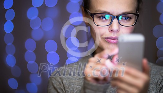 Young woman using her cell phone at home Young woman using her cell phone at home