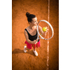 Top view of attractive young woman tennis player serving on a clay tennis court. Interesting POV shot -  sporty girl during tennis training in the club