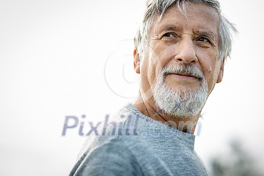 Happy senior man outdoors against the sky on a warm summer day Happy senior man outdoors against the sky on a warm summer day