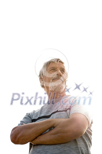 Happy senior man outdoors against the sky on a warm summer day Happy senior man outdoors against the sky on a warm summer day