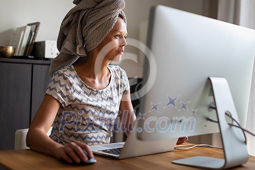 Home office/Remote work series - Pretty, young woman working at her computer from home Home office/Remote work series - Pretty, young woman working at her computer from home
