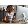 Home office/Remote work series - Pretty, young woman working at her computer from home