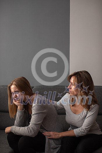 Depressed teen suffering from anxiety being taken care of by her caring mother Depressed teen suffering from anxiety being taken care of by her caring mother