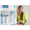 Cute female university/highschool student with books in library