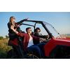 portrait of group young happy people enjoying beautiful sunny day while driving a off road buggy car on mountain nature