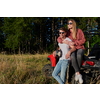 portrait of young happy excited couple enjoying beautiful sunny day while driving a off road buggy car on mountain nature