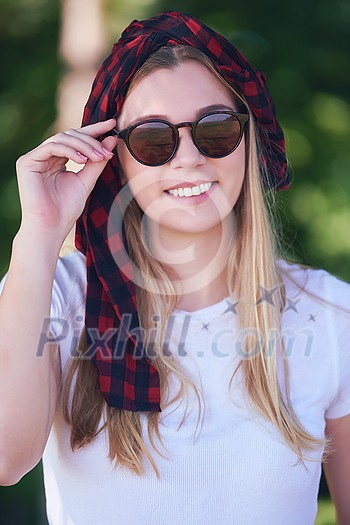 Outdoor portrait of beautiful, emotional, young woman in sunglasses. Soft background. Copy space Outdoor portrait of beautiful, emotional, young woman in sunglasses. Soft background. Copy space
