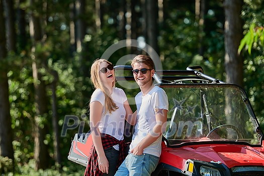 portrait of young happy excited couple enjoying beautiful sunny day while driving a off road buggy car on mountain nature portrait of young happy excited couple enjoying beautiful sunny day while driving a off road buggy car on mountain nature