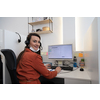 Female call center operator talking to a customer. Businesswoman in mask at the workplace in the  modern office. Social distance and safety outbreak new normal concept