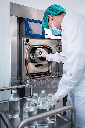 Flasks with liquids in a lab - Pharmaceutical industry factory and production laboratory (color toned image; shallow DOF), COVID vaccine production concept Flasks with liquids in a lab - Pharmaceutical industry factory and production laboratory (color toned image; shallow DOF), COVID vaccine production concept