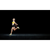 Young woman athlete running fast on dark background 