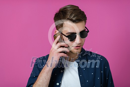 a portrait of a young man wearing a blue shirt and sunglasses using a smartphone with different facial expressions