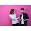 a young couple dancing in front of a pink background
