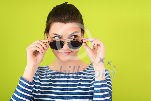 a beautiful woman in sunglasses posing in front of a green background
a beautiful woman in sunglasses posing in front of a green background