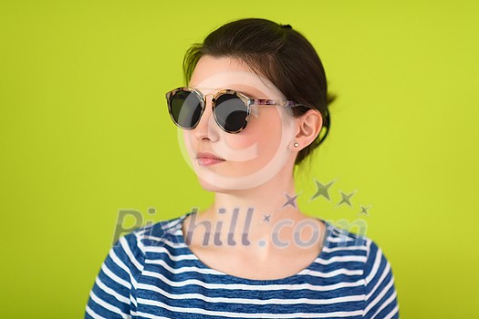 a beautiful woman in sunglasses posing in front of a green background
a beautiful woman in sunglasses posing in front of a green background