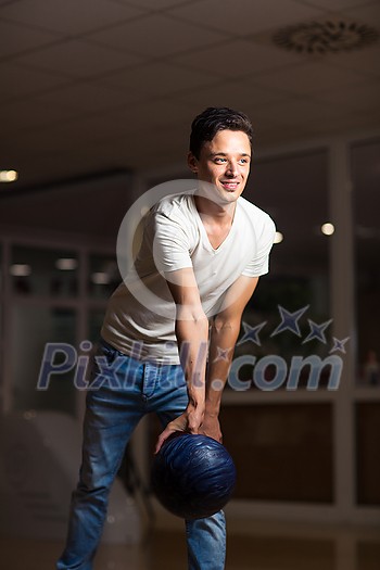 Young man at the bowling alley with the ball Young man at the bowling alley with the ball