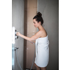 Woman taking a long hot shower washing her hair in a modern design bathroom